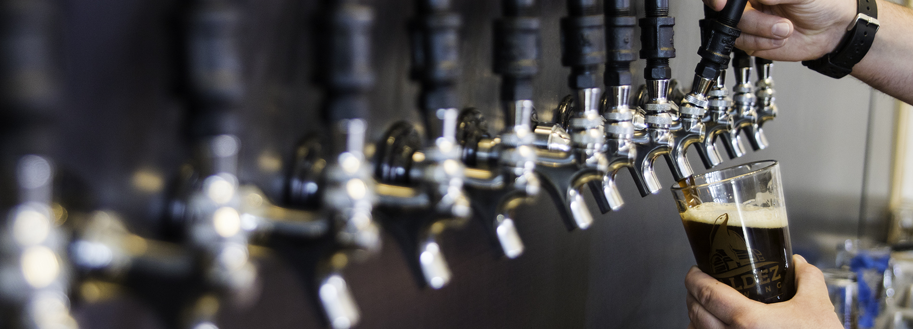 Pouring a beer at Valdez Brewing